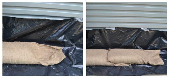 Sandbags lying on black plastic sheeting against a garage door